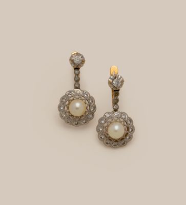 a pair of pearl and diamond earrings