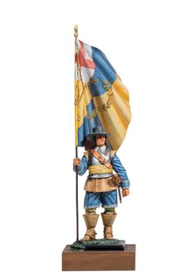 statue of a man holding a flag on a wooden base