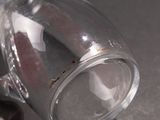 a close up of a glass cup with a handle