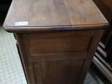 a wooden table with a drawer on it in a room