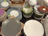 a lot of plates and bowls on the table