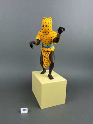 figurine of a man in a cheetah outfit standing on a cube