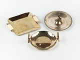 two silver plated ashtrays and a brass ashtray