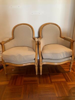 two chairs sitting next to each other on a wooden floor