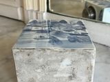 a marble box sitting on a marble table with a mirror in the background