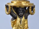 a statue of a woman holding a tray on her head