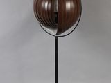 a close up of a lamp on a black stand with a white background