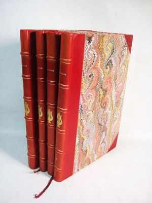 three red books are stacked on top of each other on a white surface