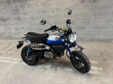 a blue and white motorcycle parked in a parking lot