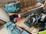 a pile of tools sitting on the floor in a garage