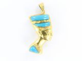 a close up of a gold and turquoise pendant on a white background