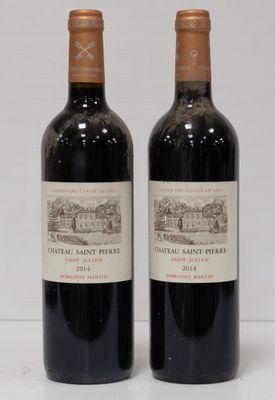 two bottles of red wine sitting next to each other on a table