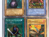 four different pokemon cards in a plastic case on a table