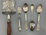 five spoons, a ladle, and a ladle on a table