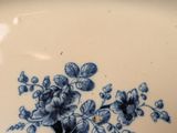 a blue and white plate with flowers on it