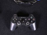 a video game controller next to a mirror on a black surface
