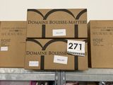 several boxes of wine are stacked on top of each other on a shelf