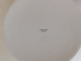 a white plate that has a white flower design on it