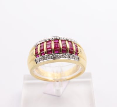 a close up of a yellow gold ring with a ruby and diamond band