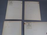 three old papers are sitting on a table with a red pen