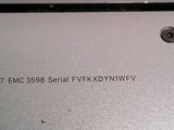 the back of a laptop with a small button on it