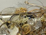a pile of gold and silver jewelry on a table