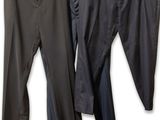 three pairs of pants hanging on a clothes rack in front of a white background