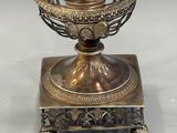 an antique silver plated vase with a horse and rider on it