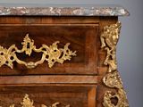 a small chest of drawers with a marble top