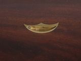 an image of a close up of a brass object on a wooden table