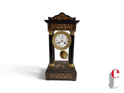a black and gold clock with a bell on it