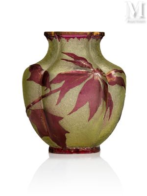 a vase that has a red and green design on it