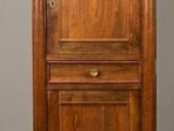 an old wooden cabinet with two doors and a drawer underneath it