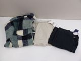 three pieces of clothing on a white table
