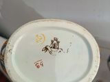 a person holding a plate with a picture of a horse on it