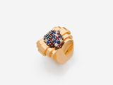 an image of a gold ring with blue, red and white stones