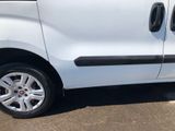 a white van parked in a parking lot next to a building