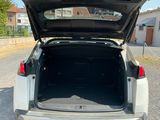 the back end of a car with its trunk open on the road