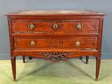 an old wooden chest of drawers with brass knobs on top of it
