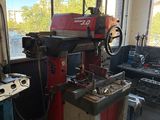 a machine that is sitting in a room with a lot of tools
