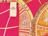 a close up of a pink scarf with a design on it