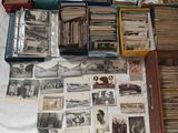 a lot of old photos and old books on a table