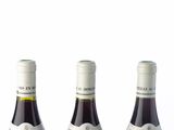 three bottles of wine that are sitting on a table