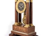 a clock that is sitting on top of a wooden stand