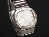 a silver watch with a white face on a black background