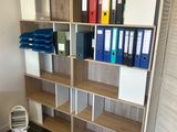 shelves with binders and binders on them in a room