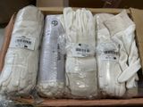 several pairs of white gloves are in a box on a table