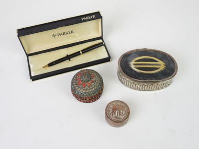 a small box with a pen and a small box with a coin