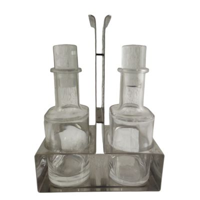 two glasses and a spoon sitting on a glass holder