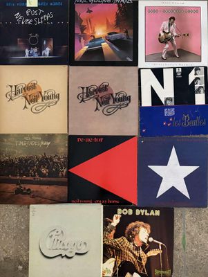 various albums of the beatles are arranged on the floor